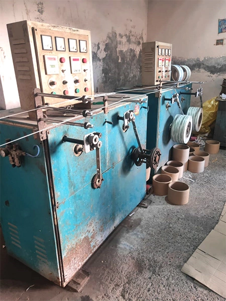 Workers operating packaging machinery